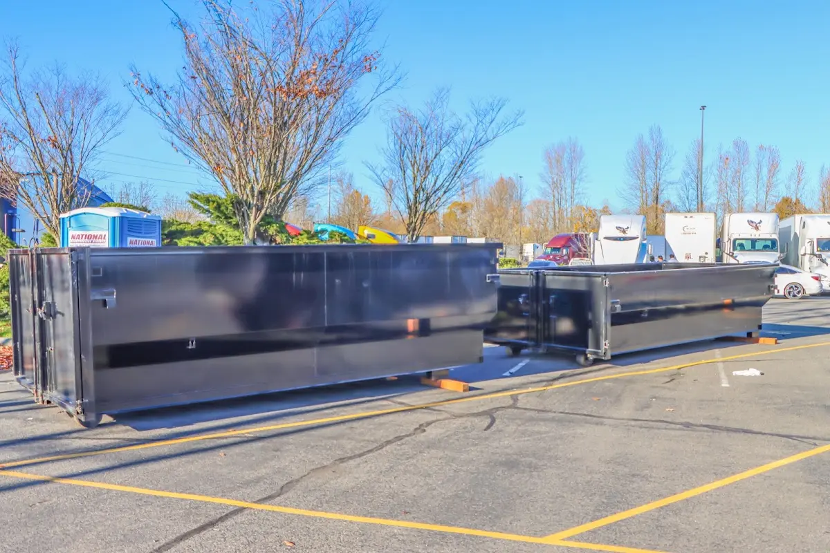 Professional dumpster rental service with roll-off container on residential driveway in South Bay